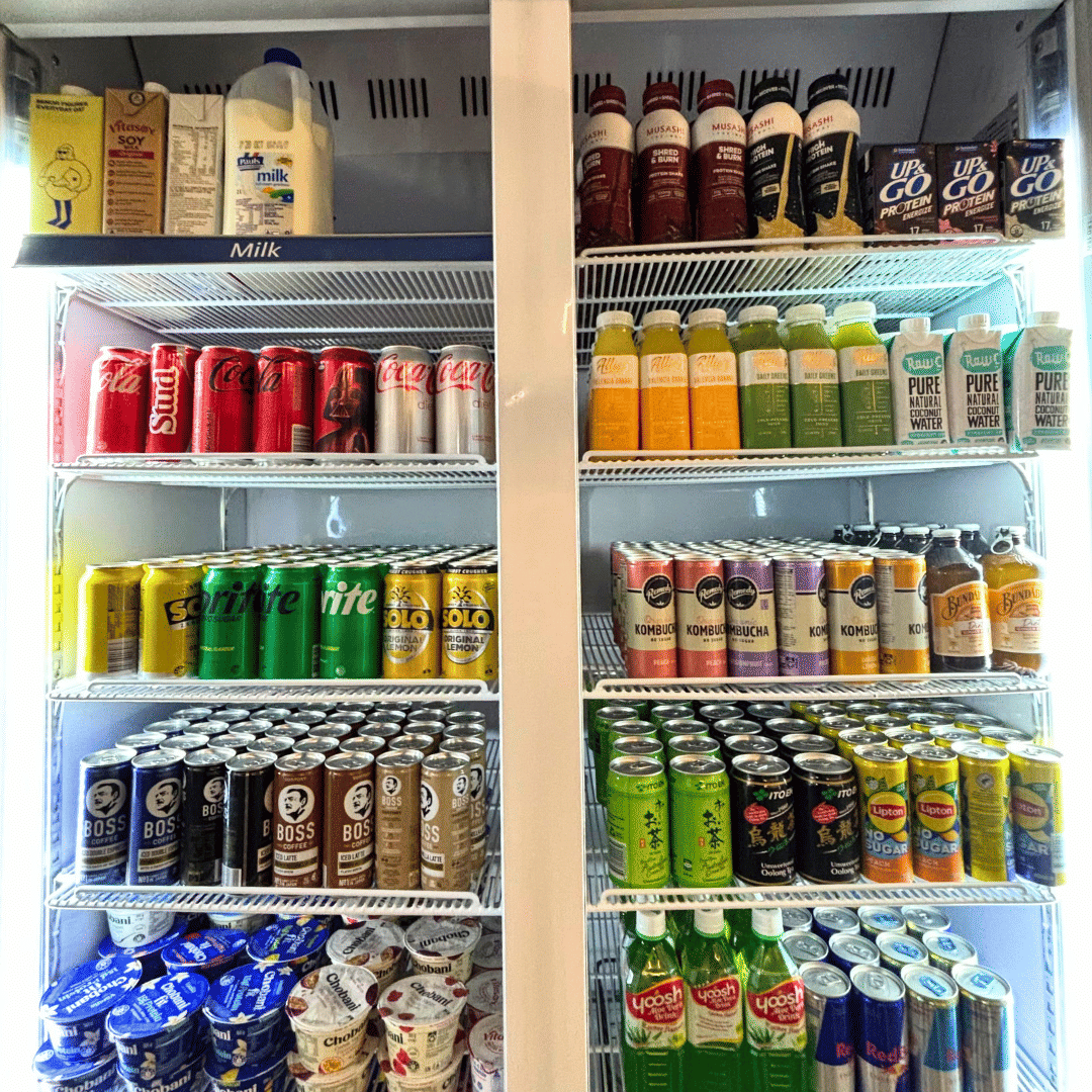 Fully stocked office fridge with beverages