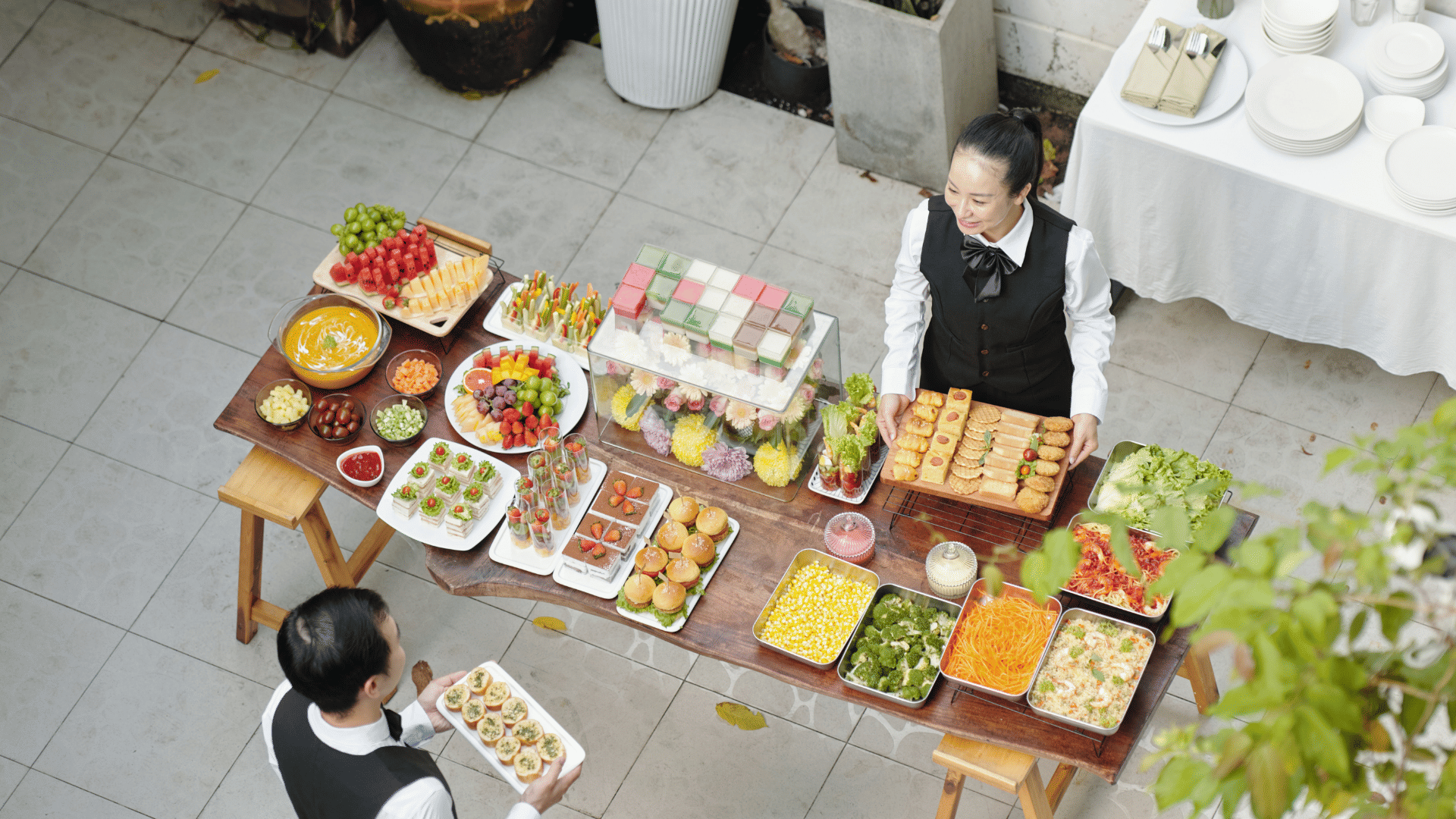 Corporate hospitality staff serving food and drinks at an office event
